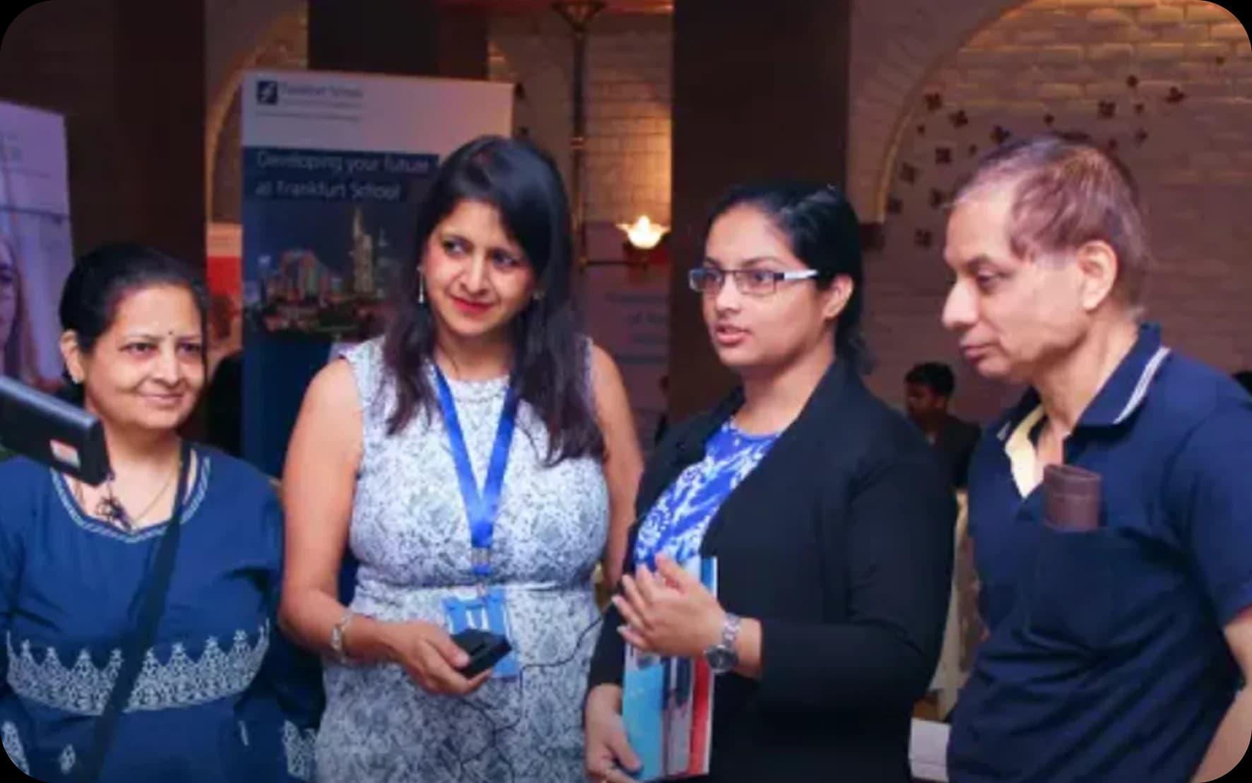 EduOptions Germany founder Renu Agarwal encouraging a student success story at Pune education fair